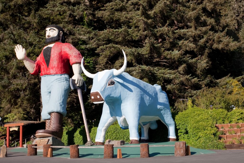 Giant statues of Paul Bunyan and Babe the blue ox guard the entrance of Trees of Mystery