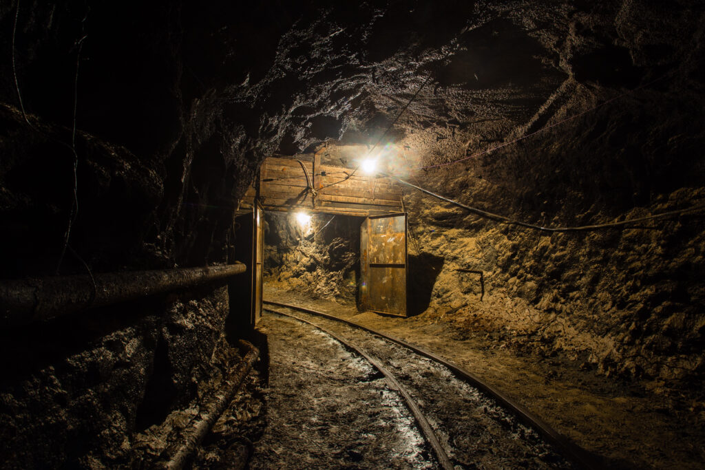 Underground mine shaft tunnel drift turn with rails