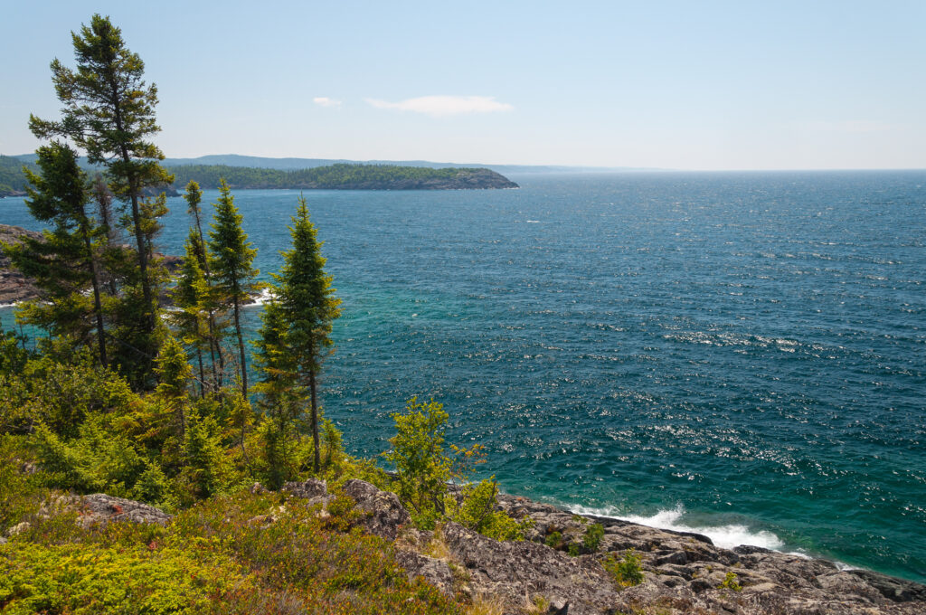 Lake Superior expands out with trees and nature surrounding.