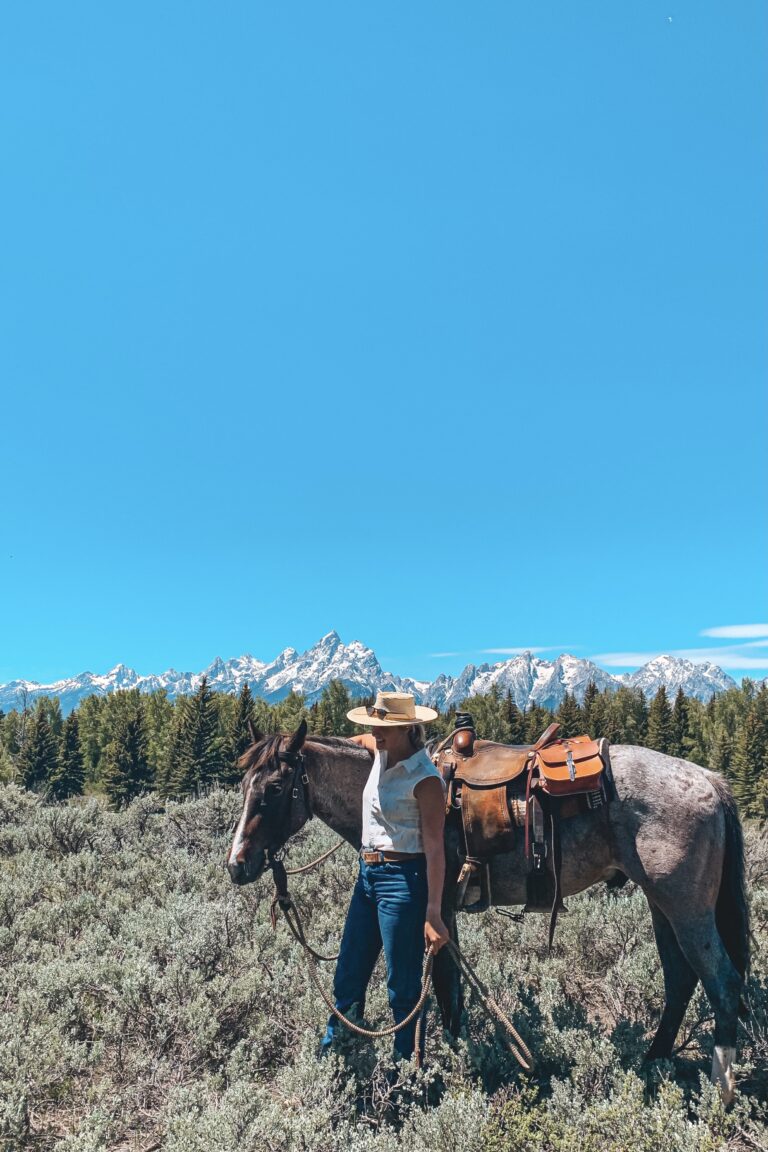 Anna Ciell (the_annaciell) walks with her horse near Grand Teton National Park.