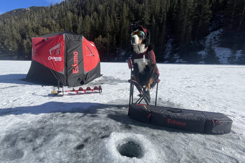 Mayor Parker relaxes in his chair on the frozen lake, waiting for a fish to bite his line.