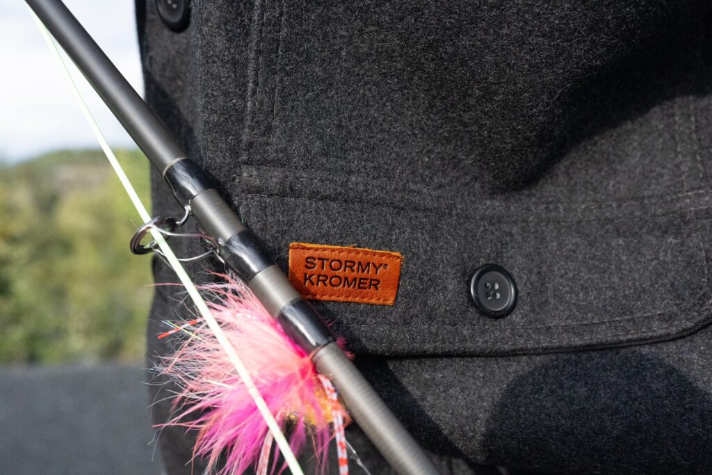 stormy kromer jacket with a fishing pole and lure next to it