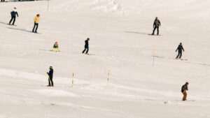 people skiing down a snow covered hill