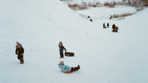 KC blog winter activities with kids kids sledding on a hill in winter