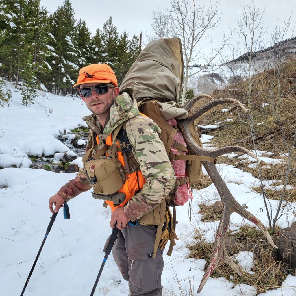 Made Like You Blog - Casey Gorsett hiking in the woods with snow on the ground and elk horns on his backpack