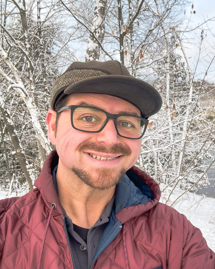 KC Blog KC Blog When is A Hat More Than Just a Hat Anthony in snowy woods with his stormy kromer hat
