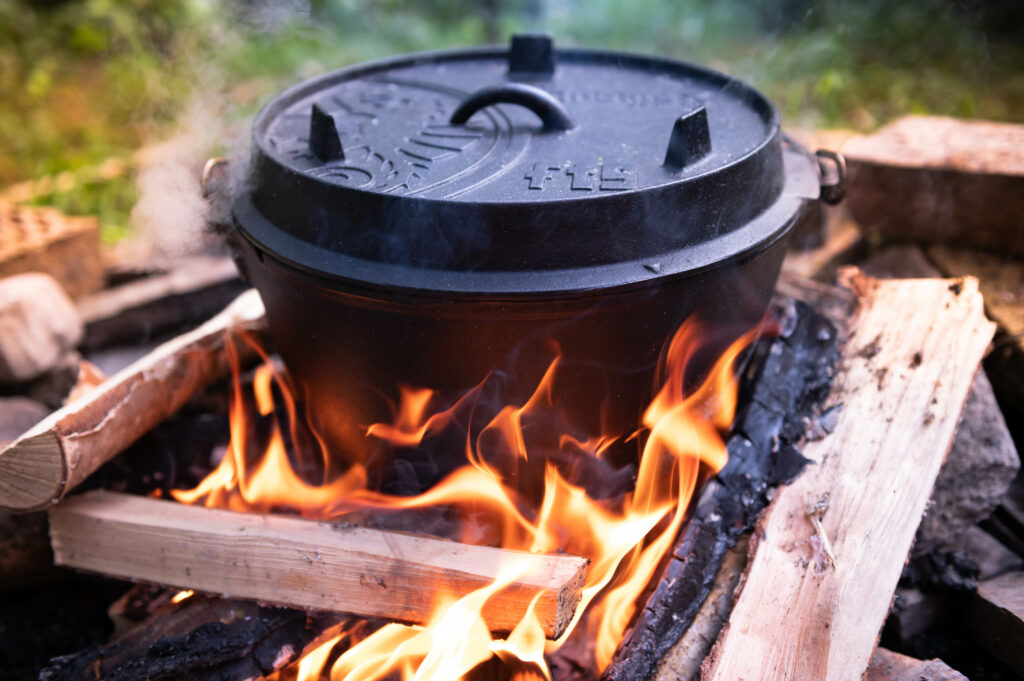 KC Camping Food Blog a dutch oven sitting in a campfire