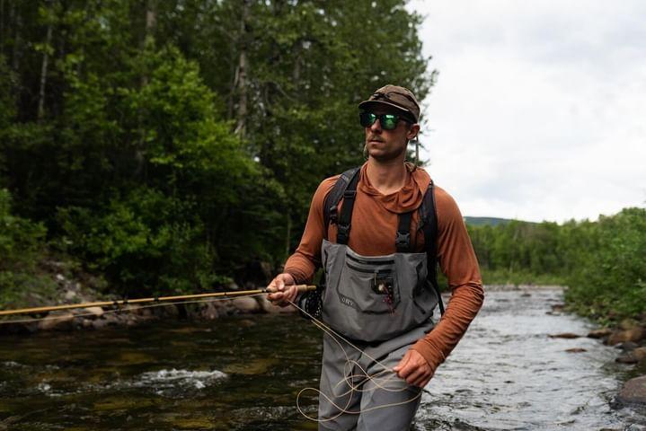 Oliver Anacan fishing on a river wearing a stormy kromer hat